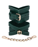 BB Store emerald green faux leather cuffs with gold hardware, cutout detailing, and adjustable buckle closure.
