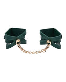 BB Store emerald green faux leather cuffs with gold chain and cutout details, adjustable buckle closure.