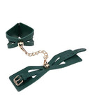 BB Store emerald green faux leather cuffs with gold chain and cutout details, adjustable buckle closure.